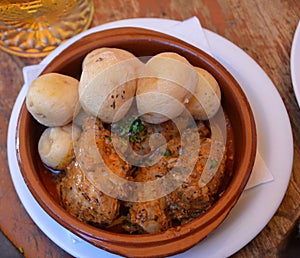 Wrinkled potatoes called papas arrugadas and rabbit, typical food from the Canary Islands, Spain.