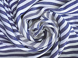 Wrinkled striped blue and white cotton or linen fabric, abstract horizontal background with crumpled wavy textile