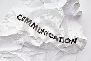 Wrinkled white paper with the word communication