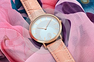 Wrist watch on silk fabric background