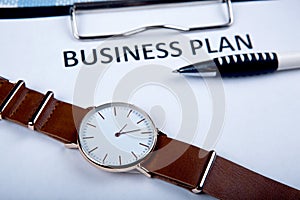 Wristwatch on a business plan documents