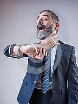 Wristwatch choking a senior business man