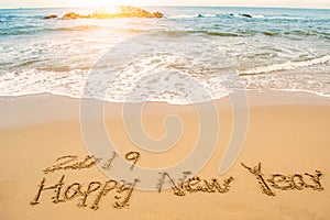 Write 2019 happy new year on beach