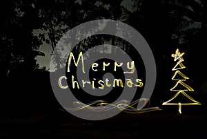 Write christmas greetings with golden lights at night