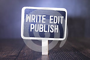 WRITE EDIT PUBLISH. notebook on a wooden table