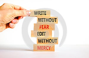 Write and edit symbol. Wood blocks with words Write without fear edit without mercy. Beautiful white background Businessman hand.