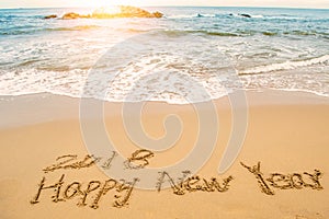 Write happy new year 2018 on beach