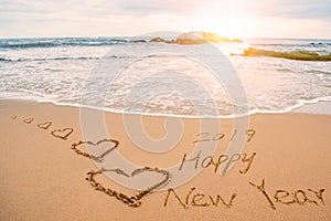 Write happy new year 2019 on beach