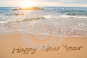 Write happy new year on beach