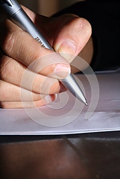 Write a letter. Hand with a pen ready to write a letter.