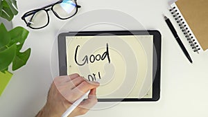 Write online good morning note on tablet screen. Electronic pencil for widget notes. Modern reminder on the screen. Top