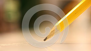 Write pencils on a white glass table close-up