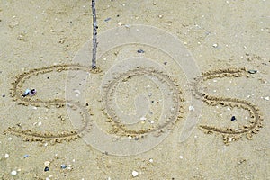 Write a symbol for help on the sand.