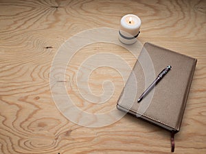 Notepad with a pen on a wooden table. photo