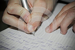 Write texts on a sheet of paper. Pen in hand