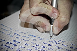 Write texts on a sheet of paper. Pen in hand