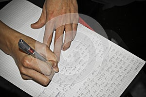 Write texts on a sheet of paper. Pen in hand