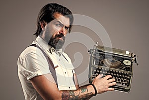 he is a writer. brutal guy in bow tie. elegant male typist. handsome hipster use technology in modern life. mature