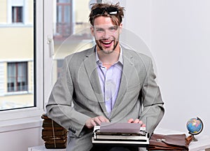 Writer or businessman wearing grey suit. Young author or editor