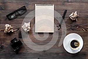 Writer concept. Pen, vintage notebook and crumpled paper on wooden table background top view copyspace, mockup