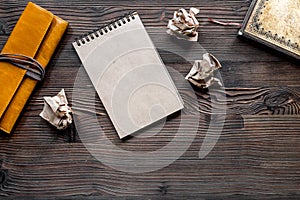 Writer concept. Vintage notebook and crumpled paper on wooden table background top view copyspace mockup