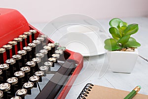 Writer or journalist workplace - vintage red typewriter on the white wooden desk