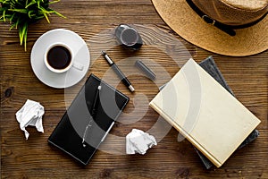 Writer`s block concept. Notebook, pen, crumpled paper on dark wooden background top-down flay lay