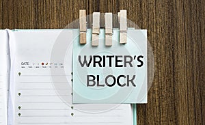 Writer S Block notes paper and a clothes pegs on wooden background