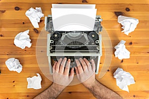 Writer`s block. Typewriter and crumpled paper on work desk. Creative process concept