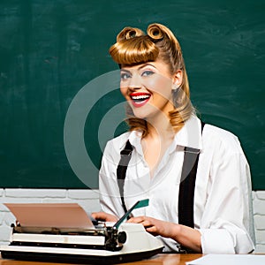 Writer or secretary. Vintage. Beautiful girl with a typewriter. Retro style. Clever beauty blonde. Journalism.