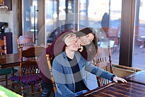 Writer with smartwatch on hand waiting business partner in cafe