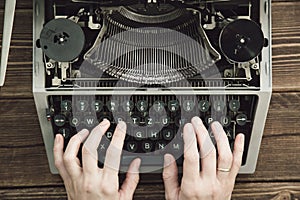 Writer typing with retro writing machine.