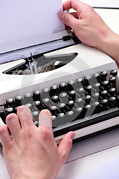 Writer typing with retro writing machine. Typography and writing