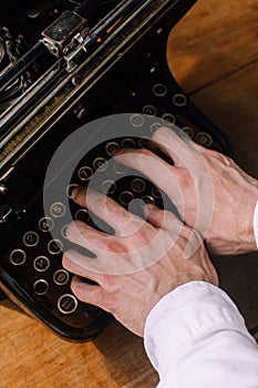 A writer typing on a vintage typewriter