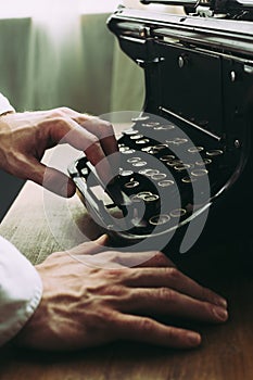 A writer writing a novel, using old vintage typewriter