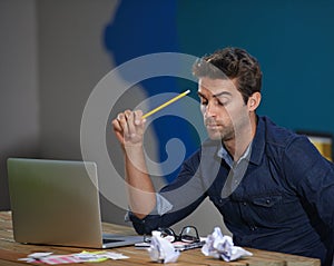 Writers block Hes got creative clog. A thoughtful young entrepreneur using his laptop.