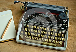 Writers block, Old typewriter with a notebook and a pen
