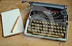 Writers block, Old typewriter with a notebook and a pen