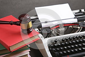 Writers desk - typewriter, books and judge's gavel, copyright protection law concept