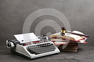 Writers desk - typewriter, books and judge's gavel, copyright protection law concept