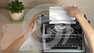 Writing a book and typing old typewriter, top view. Man typing on old vintage retro typewriter. News, media or