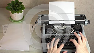 Writing a book and typing old typewriter, top view. Man typing on old vintage retro typewriter. News, media or