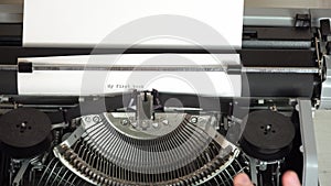 Writing a book and typing old typewriter, top view. Man typing on old vintage retro typewriter. News, media or