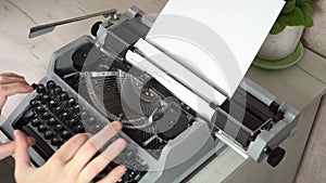 Writing a book and typing old typewriter, top view. Man typing on old vintage retro typewriter. News, media or