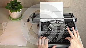 Writing a book and typing old typewriter, top view. Man typing on old vintage retro typewriter. News, media or