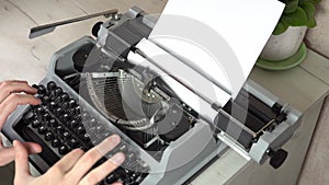 Writing a book and typing old typewriter, top view. Man typing on old vintage retro typewriter. News, media or