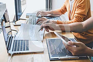 Writing codes and typing data code technology, Programmer cooperating working on web site project in a software developing on