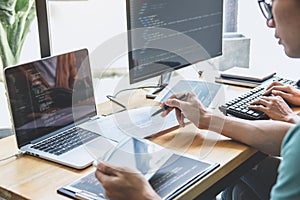 Writing codes and typing data code technology, Programmer cooperating working on web site project in a software developing on