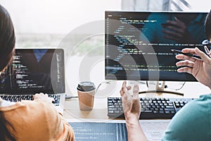 Writing codes and typing data code technology, Programmer cooperating working on web site project in a software developing on