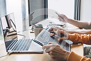 Writing codes and typing data code technology, Programmer cooperating working on web site project in a software developing on